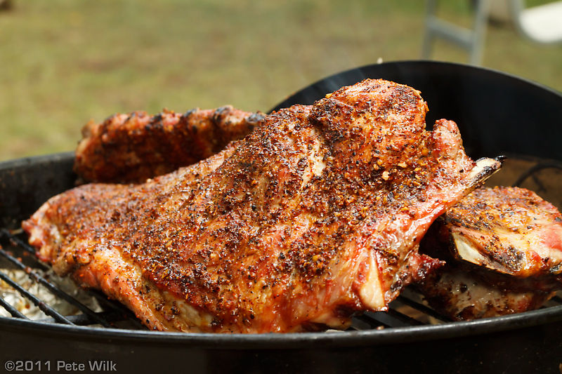 Grilling ribs on the BBQ.  These took about 2 hours and were prepared with a dry rub and basted with bacon fat--pig^2!