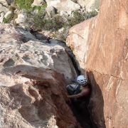 Roxanne escaping the heat by making a chimney out of a face climb.