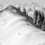 Skiers nearing the top of a knob on the west side of Beartrap.