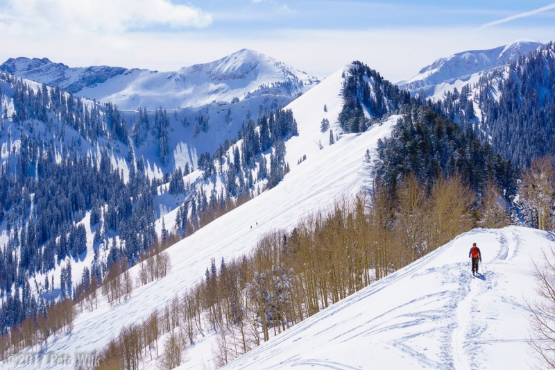 Skiier hiking up the ridge towards the back of Silver Fork.