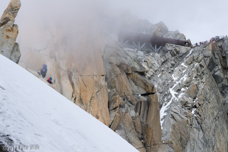 The beginnings of the turn in weather and in fluidity of the climbing.  The Russian team of three is about to create a traffic jam.  Note that there\'s still a fair amount of climbing before getting to the platform.