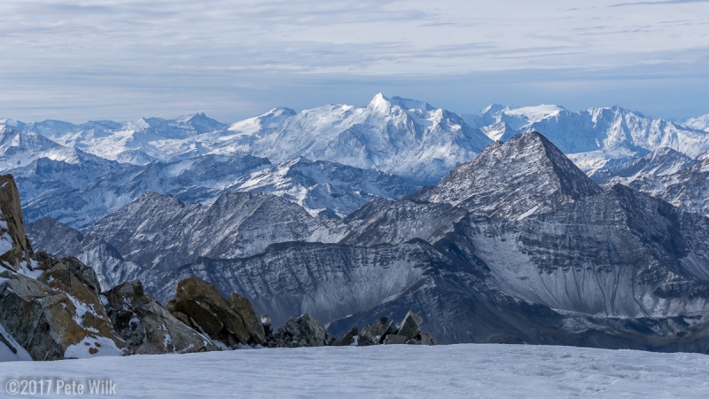 Dramatic lighting and mountain ranges on the Italian side.
