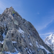 The route includes a couple minor downclimbs.  Here has the duty of cleaning the last but of protection I placed.  Mont Blanc in the background.