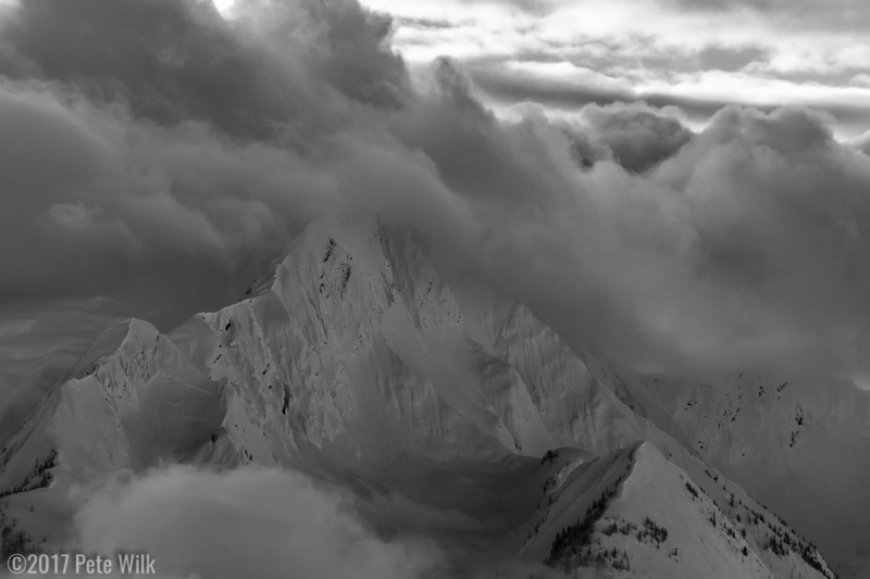Moody clouds in the distance. A crownline is visible on the left ridge.