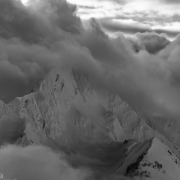 Moody clouds in the distance. A crownline is visible on the left ridge.