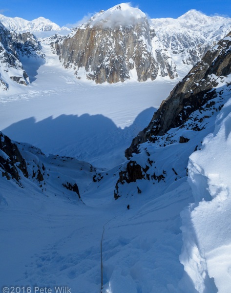 Matt 200' below me after I topped out the coulior.  I'm in the sun and getting warm.  The snow at my feet is deceptively steep.