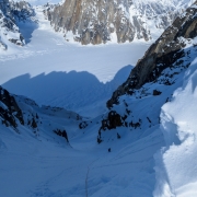 Matt 200' below me after I topped out the coulior.  I'm in the sun and getting warm.  The snow at my feet is deceptively steep.