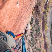 Looking down from the P6 hanging belay.  Our bivy is in the space behind the large pinnacle below me.