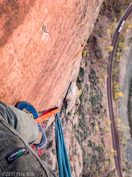 Looking down from the P6 hanging belay.  Our bivy is in the space behind the large pinnacle below me.