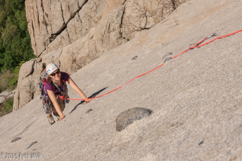 Carly making her way up the last few feet of the slab pitch.