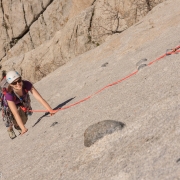 Carly making her way up the last few feet of the slab pitch.