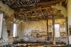 Inside one of the buildings.  Since there are no doors cows have ended up sheltering here and the floor is dried up manure.