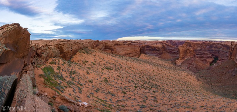 Panoramic from the Crack-in-the-Rock.  The dark wide crack at bottom left is how the trail goes from the rim to the sand.