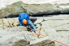 Carly climbing the 5.7 pitch in mountain boots.  The moat crossing below was an interesting one.