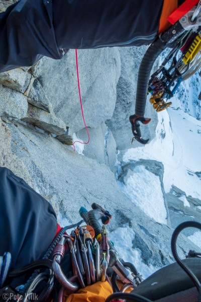 Perhaps the worst anchor stance I've ever rappelled off of.  The anchor was position just over a lip of a small roof so that it wasn't just free hanging, but undercut for the feet.  I used a small cam off to my left to keep my feet on something.  Micah earning his money by doing the free hanger.