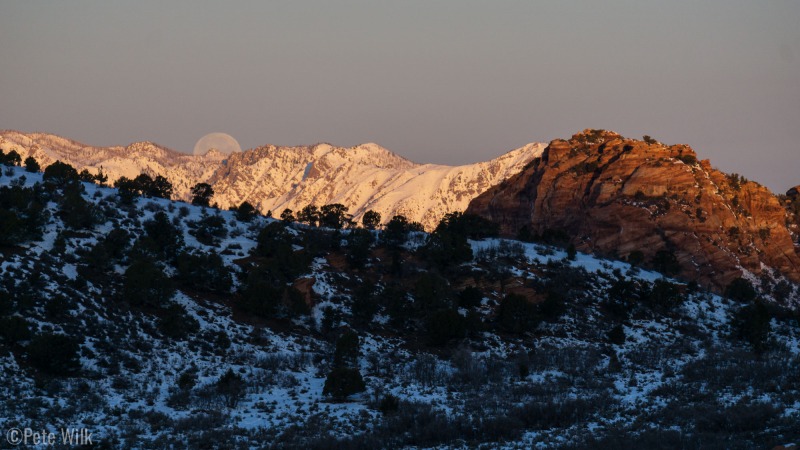 Sunrise, moonset.  Desert rock, winter snow.