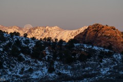 Sunrise, moonset.  Desert rock, winter snow.