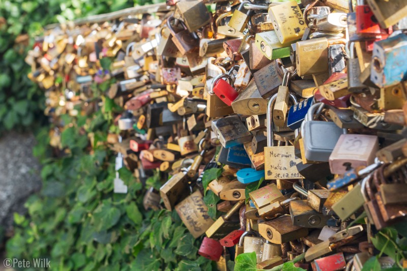 Railing littered with hundreds or thousands of relationship locks.