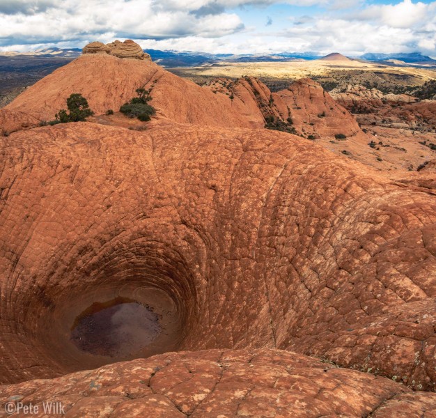 The Vortex is a cool depression in a sandstone ridge that appears to not have an outlet.  I assume it formed via wind erosion.