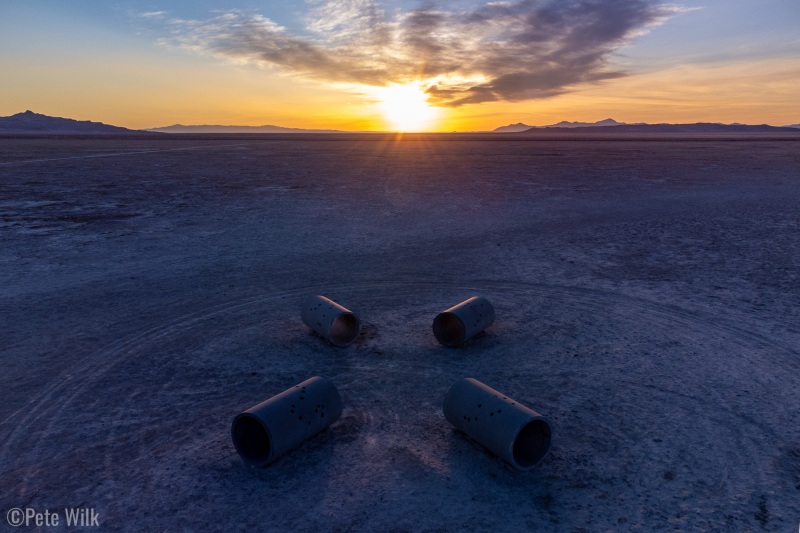 A photo that emphasizes the amount of change there is in the sun's position in the sky during the year.  The sun rose half way between the two sets of tunnels.  This emphasizes just how much more north the sun rises in the summer and conversely in the winter.
