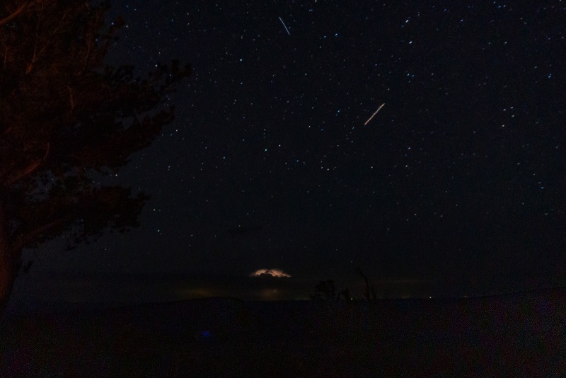 Far off lightning along with the stars and Milky Way.